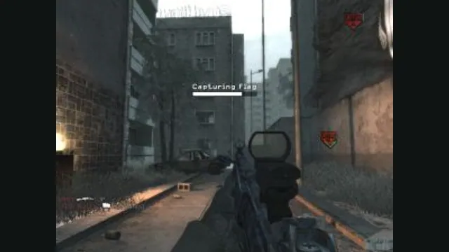 A player captures a flag on an urban multiplayer map in Call of Duty 4. Original-game reference.