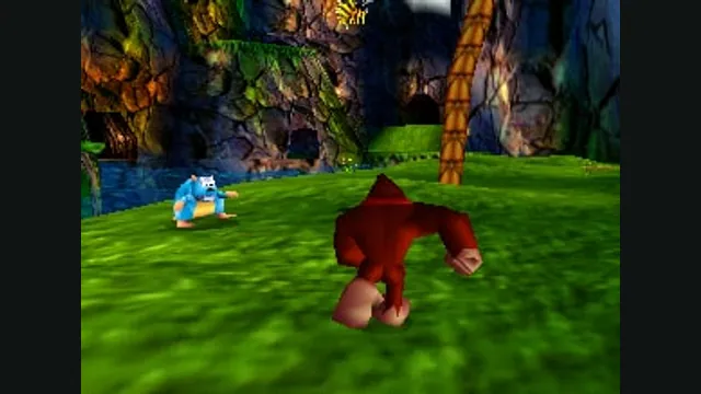 Donkey Kong runs toward an enemy on the grass in Jungle Japes. Original-game reference.