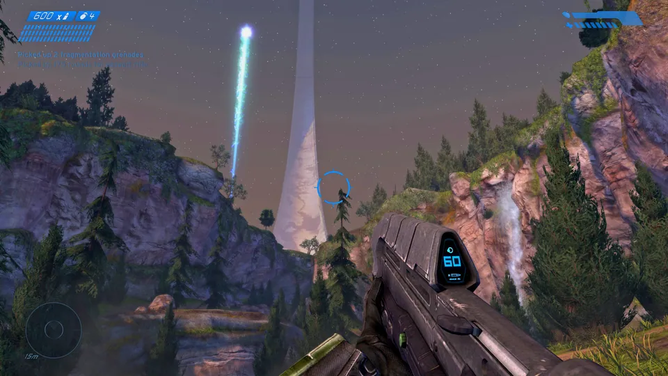 Halo’s ring stretches above a rocky valley in Halo: Combat Evolved Anniversary. Remastered-game reference.