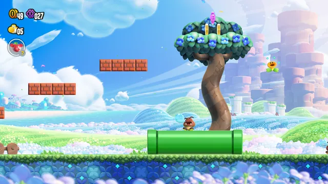 A Goomba rests on a green pipe beneath a flowering tree in Wonder’s first course, in the creator’s macOS recompilation screenshot.