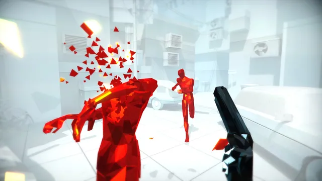 Red figures shattering during a first-person action scene in retail SUPERHOT. Retail-game reference.